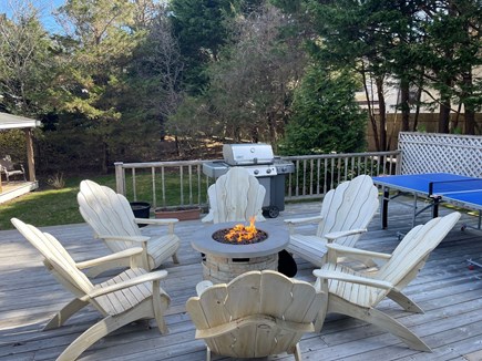 Edgartown Martha's Vineyard vacation rental - Partial view back deck w/ gas firepit table and ping pong table.