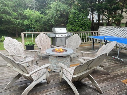 Edgartown Martha's Vineyard vacation rental - Partial view of back deck with gas fire pit table and pool table.