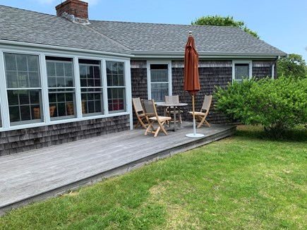 Chilmark, Menemsha Martha's Vineyard vacation rental - front deck with table, chairs and umbrella