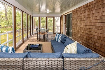 Oak Bluffs Martha's Vineyard vacation rental - First floor screened porch with sectional couch and dining table