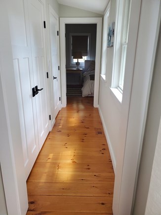 Vineyard Haven, West Chop  Martha's Vineyard vacation rental - Hallway with W/D on left and leading to primary suite