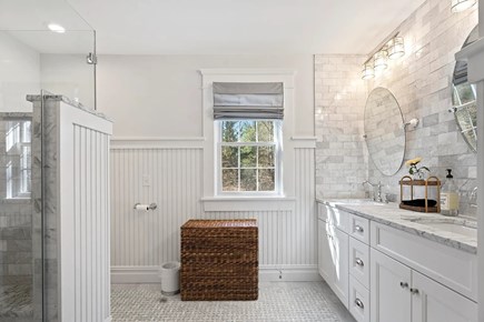 Edgartown Martha's Vineyard vacation rental - Primary bathroom has two vanities, marble accents and wainscoting