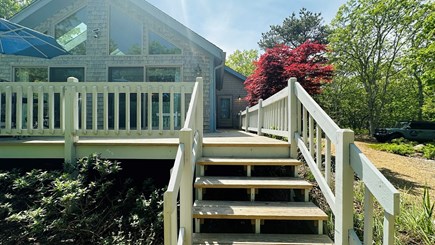 Edgartown Martha's Vineyard vacation rental - Wooden stairs leading to a raised deck with outdoor dining.