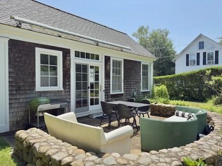 Vineyard Haven, Martha's Viney Martha's Vineyard vacation rental - A curved stone wall surrounds patio seating with awning.