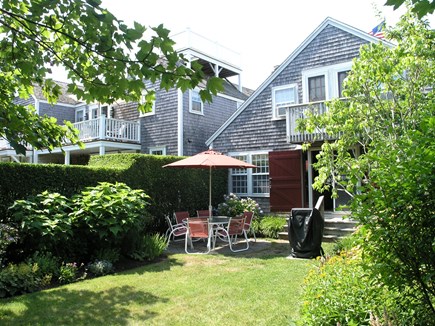 Nantucket town Nantucket vacation rental - Backyard w/ garden, dining area, grill & gate access to Stilldock