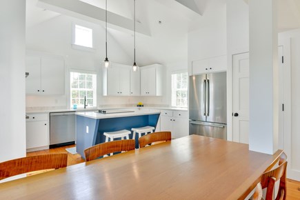 Mid-island Nantucket vacation rental - A full sized kitchen with island seating and a dining area.