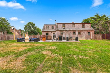 Mid-island Nantucket vacation rental - View from backyard with deck and patio